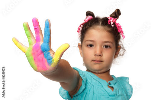 Cute girl showing her colorful hands smiling