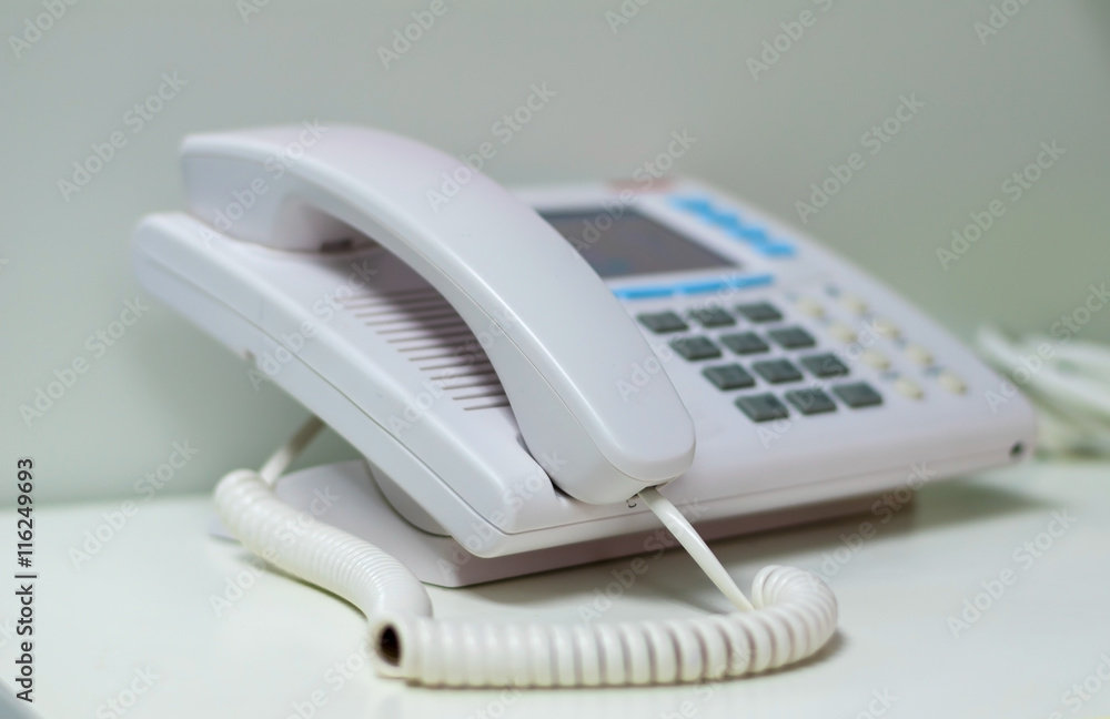 White telephone on white table White telephone on white table
