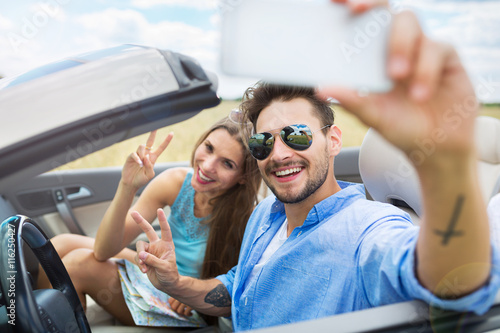 Couple taking a selfie while out on a road trip   © pikselstock