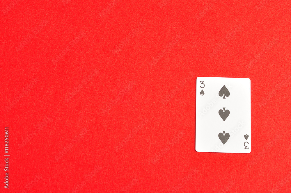 Playing card. Three of spades isolated on a red background