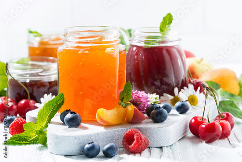 assortment of jams, seasonal berries and fruits 