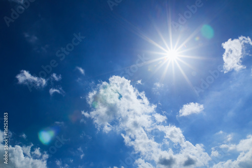 Blue sky with clouds and sun beam