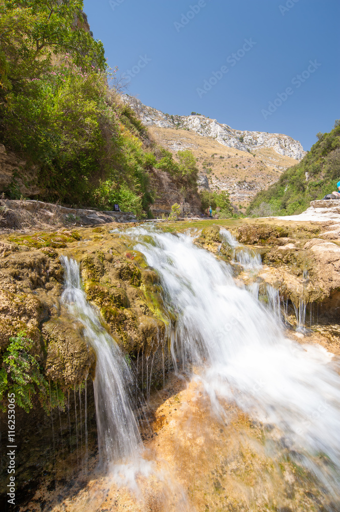 The natural reserve Cavagrande, Sicily, with a view of a smal fall and of the canyon The natural reserve Cavagrande, Sicily, with a view of a smal fall and of the canyon