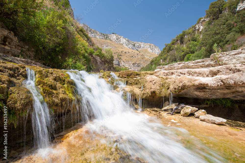 The natural reserve Cavagrande, Sicily, with a view of a smal fall and of the canyon The natural reserve Cavagrande, Sicily, with a view of a smal fall and of the canyon