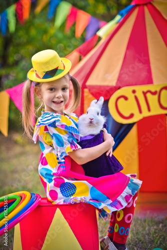 girl at the circus with a rabbit in her arms