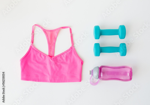 close up of sports top, dumbbells and bottle