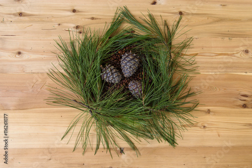 Pine cones and needles closeup on a wooden table