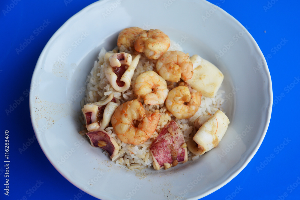 Mixed seafood dish sir fired with garlic, top on rice , Thai foo Mixed seafood dish sir fired with garlic, top on rice , Thai foo