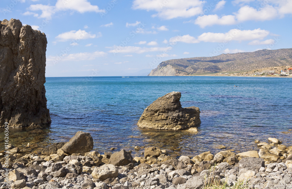 Large boulders stick out of the water in the Kutlaksky Bay.Crimea.