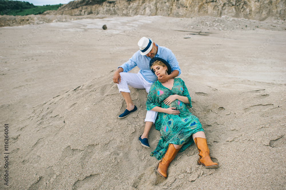 Pregnant woman and man photo shoot in a stone quarry Pregnant woman and man photo shoot in a stone quarry