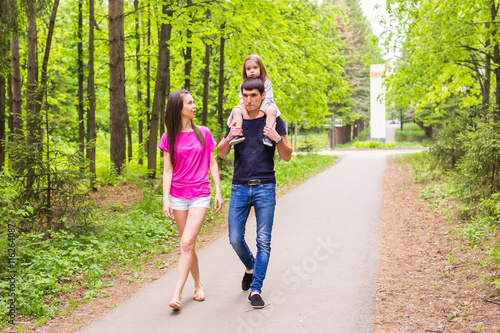 Fototapeta Naklejka Na Ścianę i Meble -  Happy family having fun outdoors and smiling