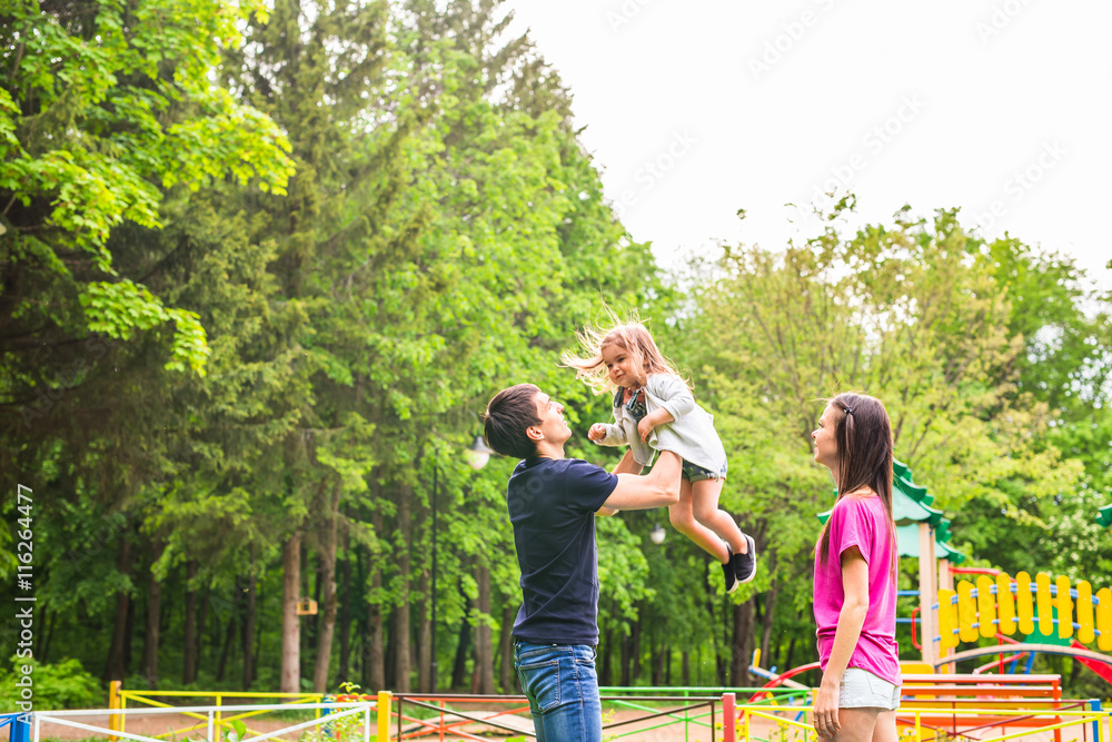 Happy family having fun outdoors and smiling Happy family having fun outdoors and smiling