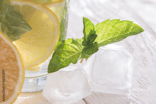 Soft drink with lemon, ice and mint photo