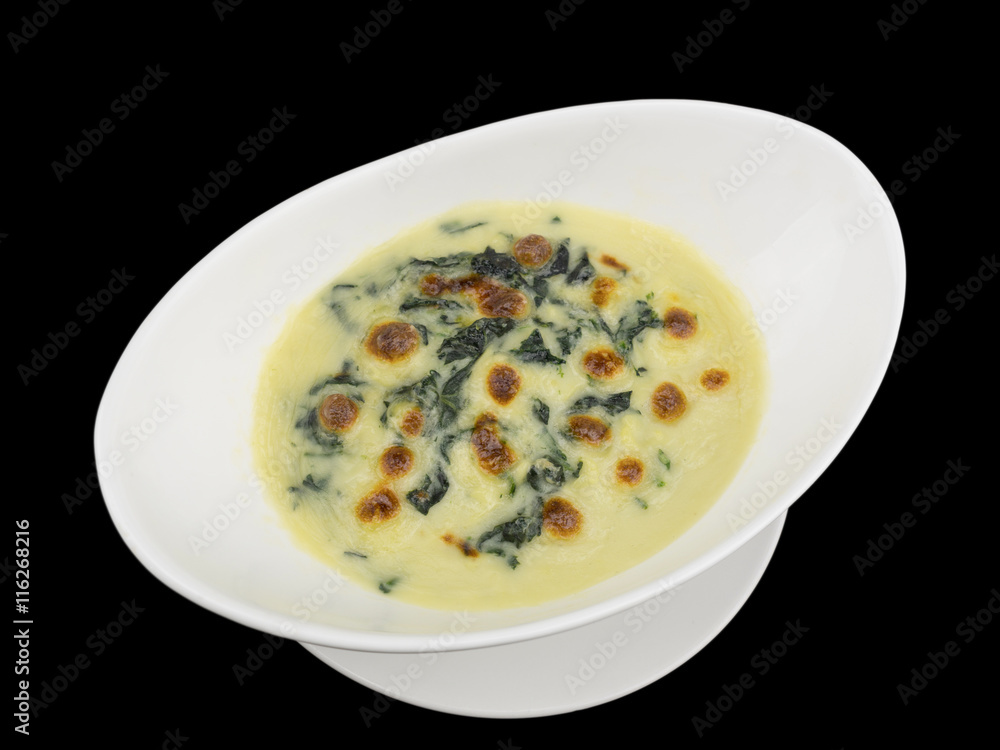Baked spinach with cheese isolated on the black background with clipping path Baked spinach with cheese isolated on the black background with clipping path