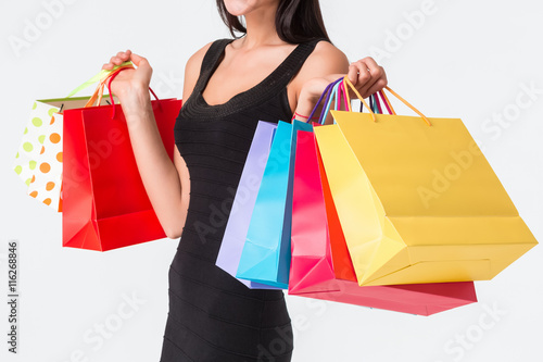 Unrecognizable woman holding multicolored shopping bags