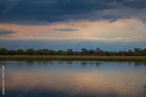 Fototapeta Naklejka Na Ścianę i Meble -  Evening sunset over a pond