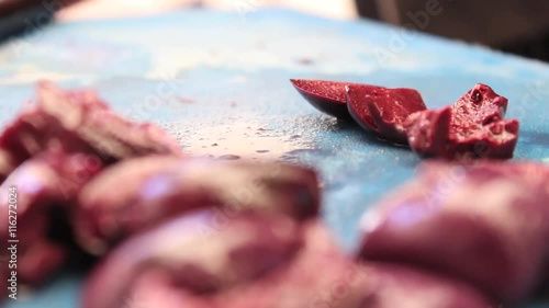 Man cutting olives for a salad. 