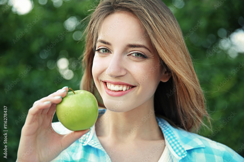 Beautiful girl with apple in garden Beautiful girl with apple in garden