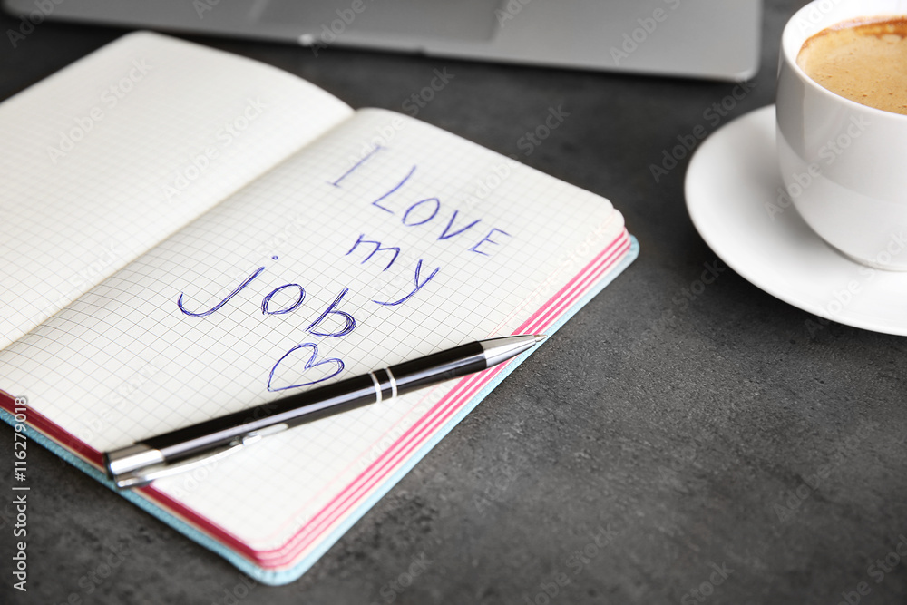 I love my job concept. Open notebook on office table I love my job concept. Open notebook on office table