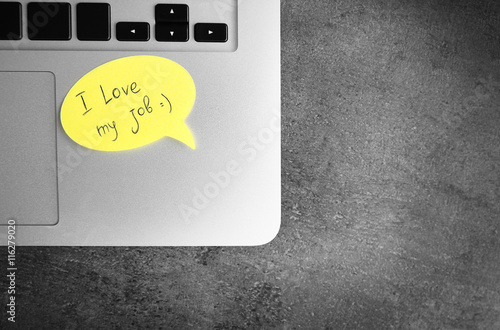 I love my job concept. Laptop with yellow sticker
