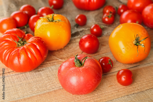 Rustic composition of tomatoes and sackcloth on wooden background