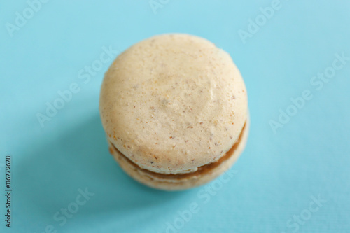 Tasty macaroon on light blue background