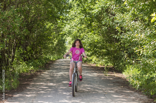 Wallpaper Mural Tired teen girl rides a bicycle on the road in a summer day Torontodigital.ca