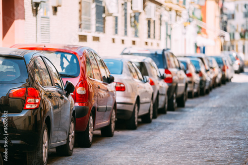 Cars Parked On Street In European City In Summer Day.