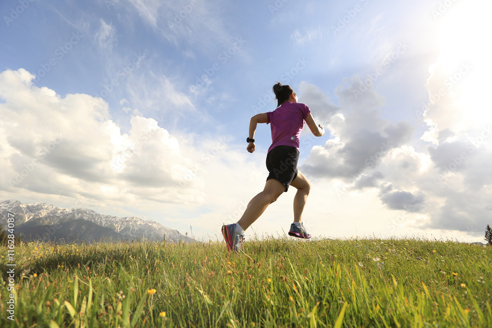 healthy young woman trail runner running on beautiful mountain peak healthy young woman trail runner running on beautiful mountain peak