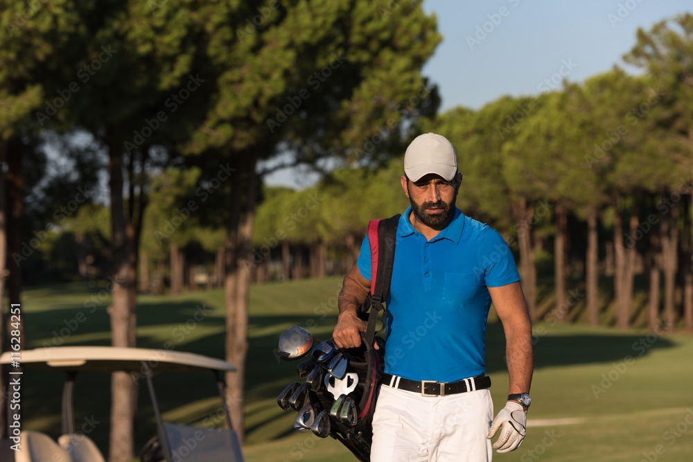 golfer  walking and carrying golf  bag