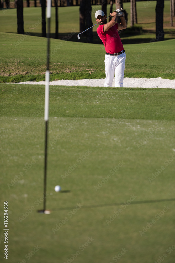 Fototapeta premium golfer hitting a sand bunker shot
