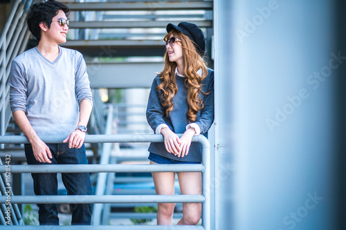 Men and women wearing sunglasses Standing on a steel frame const