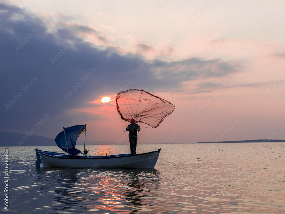 Sunset time to Golyazi lake and fisherman at Bursa, Turkey Sunset time to Golyazi lake and fisherman at Bursa, Turkey