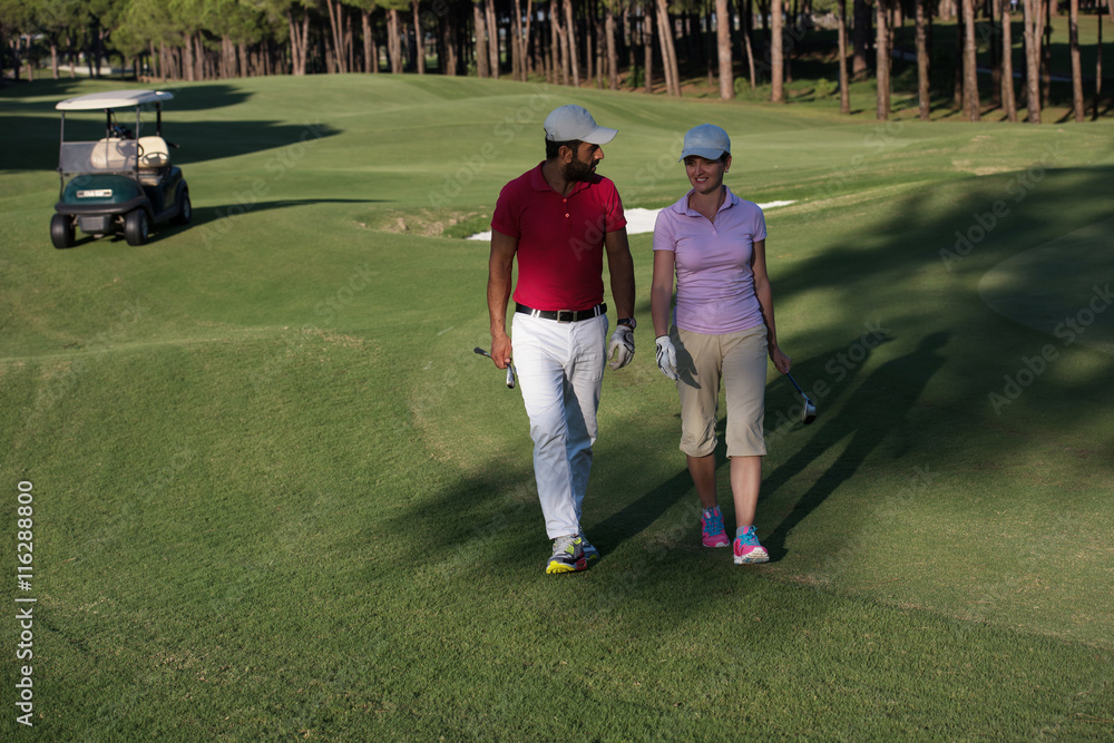 couple walking on golf course