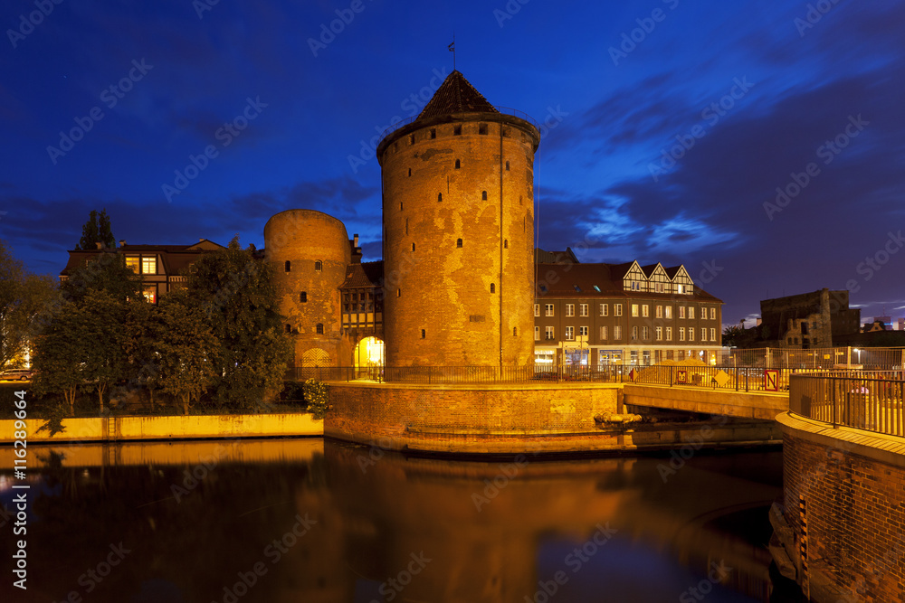 Medieval city tower and walls of Gdansk, Poland at sunset 