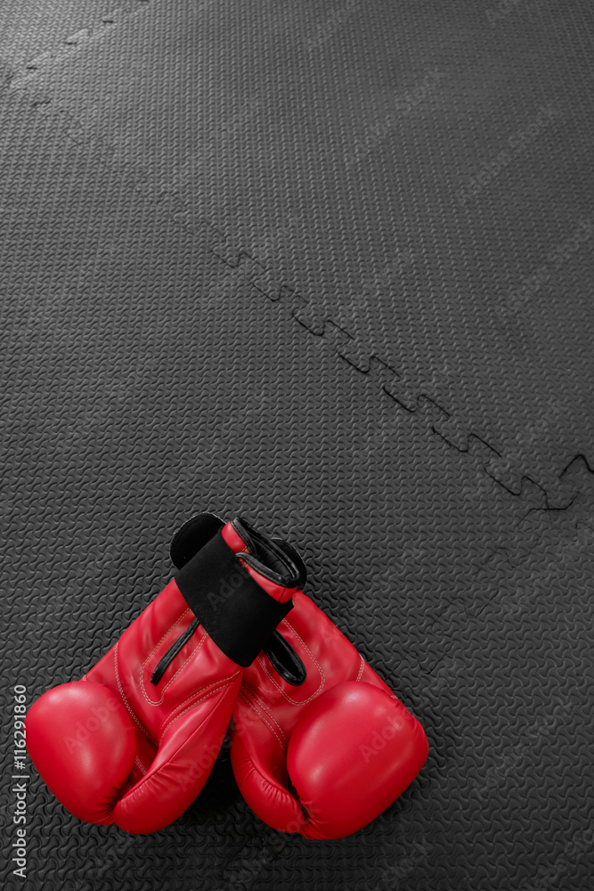 boxing gloves hang on nail on texture wall with copy space for t
