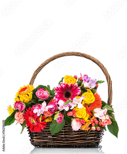 Colorful flowers in the wicker on white background