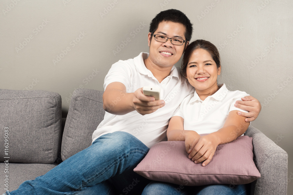 asian couple relaxing on couch asian couple relaxing on couch