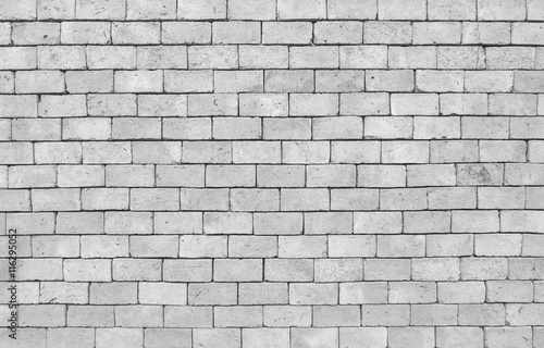 Closeup surface brick pattern at old brown stone brick wall texture background in black and white tone