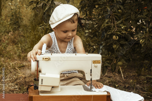 boy sews the sewing machine