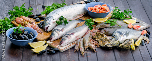 Raw seafood on a wooden table.