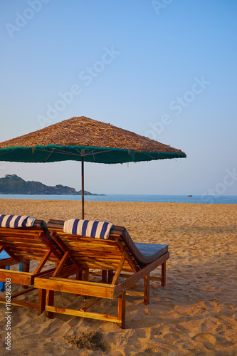 empty beach chairs on a tropical beach