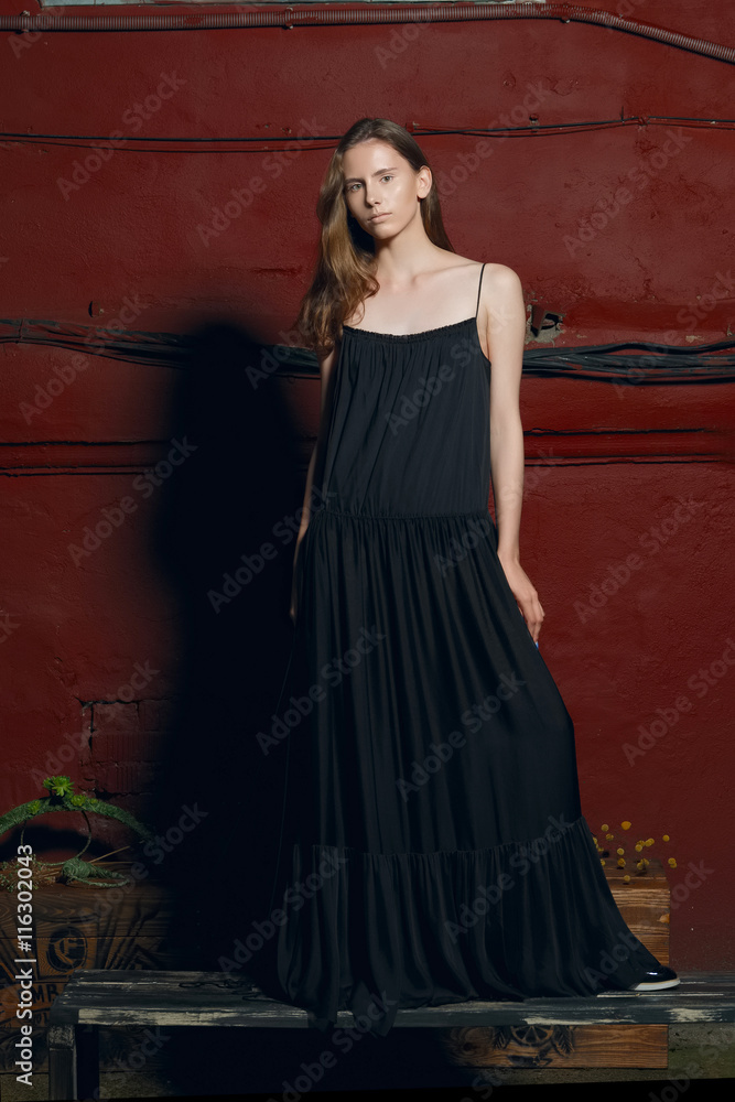 fashion model in long designers black dress in night show fashion model in long designers black dress in night show