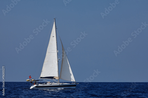 The white sails of yachts on the background of sea and sky © Roman Ribaliov
