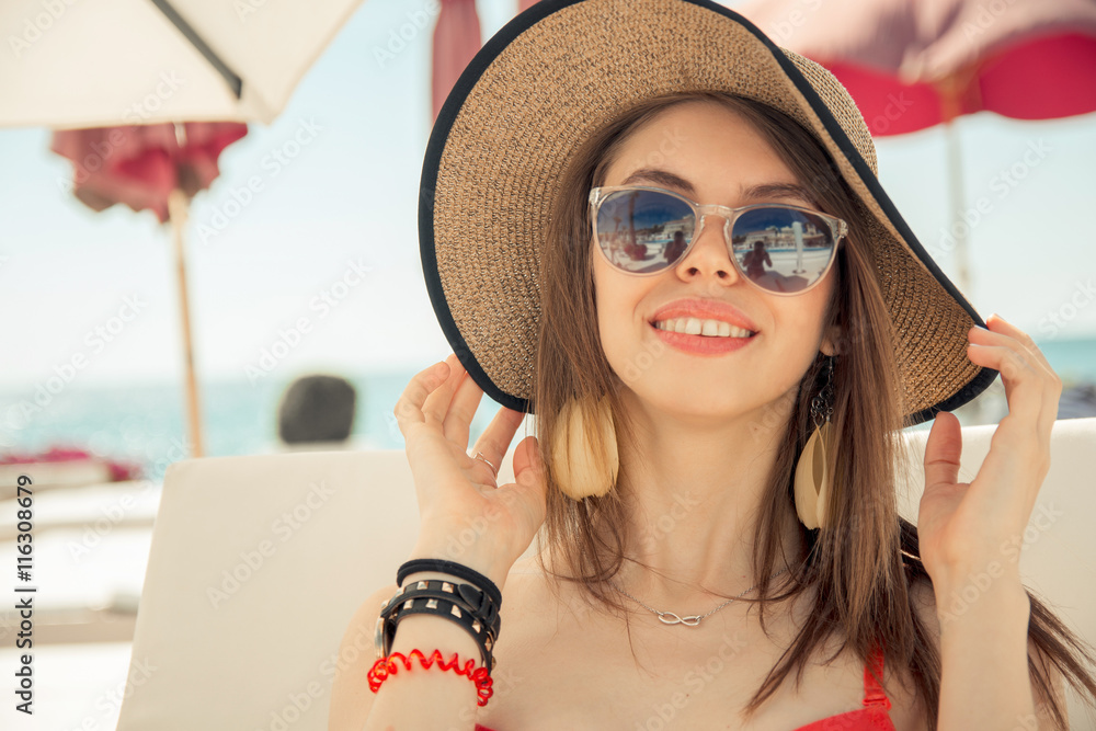Young woman in swimwear is posing on beach