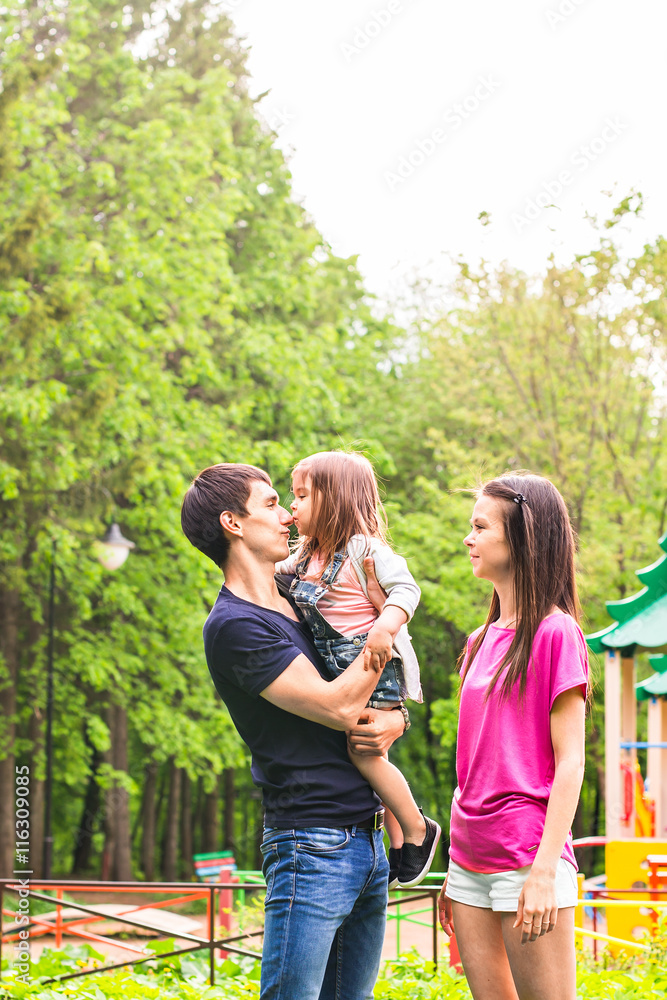 happy young family spending time outdoor on a summer day happy young family spending time outdoor on a summer day