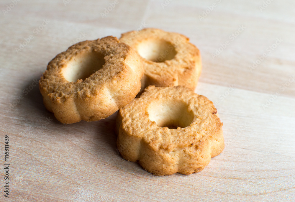 Three cookies on wooden desk. Closeup bright and nature light Three cookies on wooden desk. Closeup bright and nature light