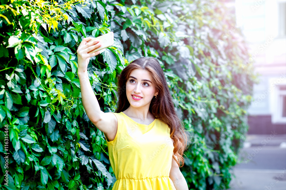 young girl with flowers summer in yellow dress making selfie young girl with flowers summer in yellow dress making selfie