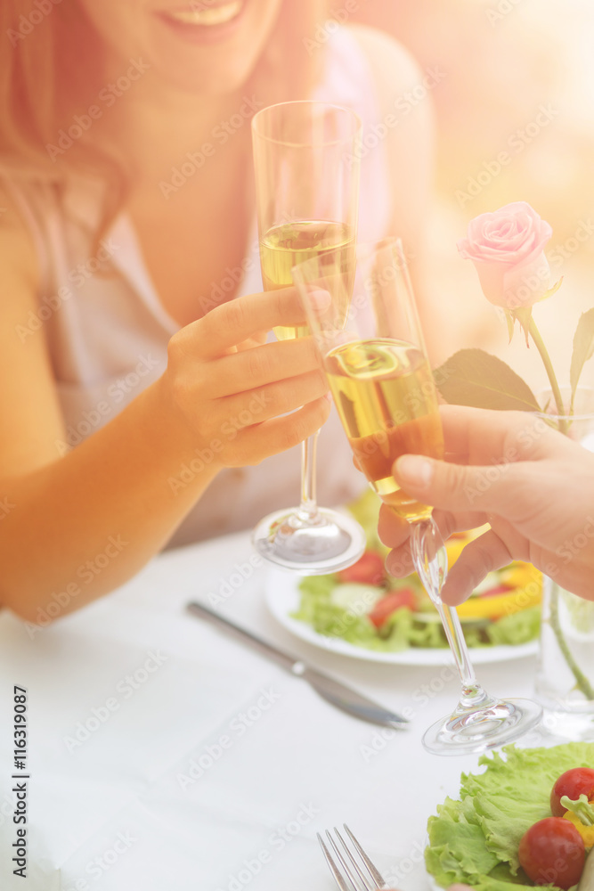 Toned picture of couple drinking wine from glasses while spending time in cafe or restaurant by sea. Summer or spring holidays and dating concepts. Toned picture of couple drinking wine from glasses while spending time in cafe or restaurant by sea. Summer or spring holidays and dating concepts.