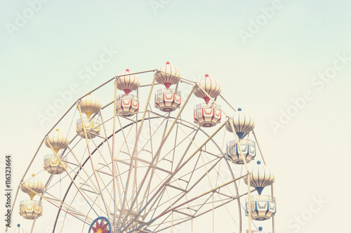 ferris wheel against blue sky  vintage filter effects